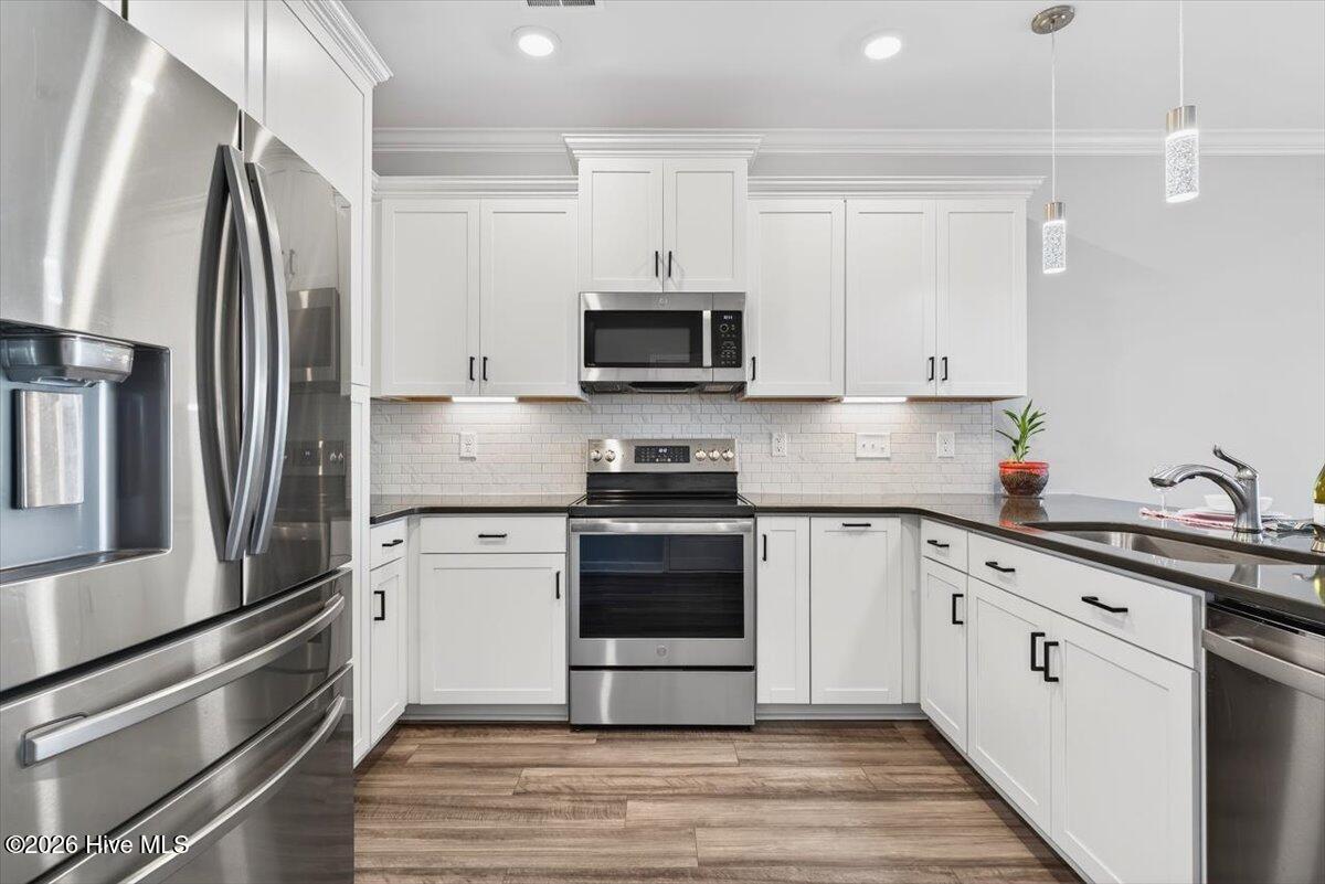 8840 Radcliff Drive Northwest Calabash, NC 28467 - Photo 13 of 54 Updated kitchen featuring ample cabinetry, generous counter space, and a functional layout for cooking.