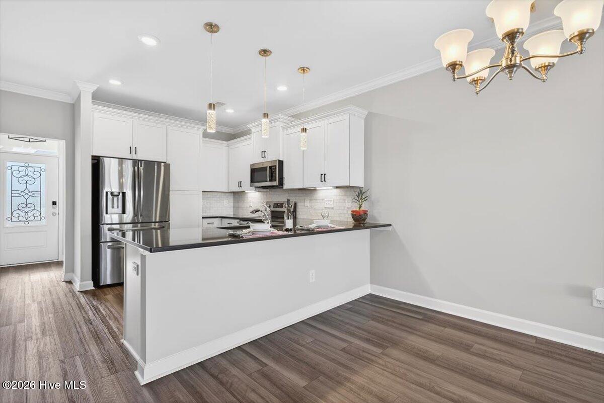 8840 Radcliff Drive Northwest Calabash, NC 28467 - Photo 14 of 54 Bright dining area with room for a full-size table and effortless connection to the kitchen.