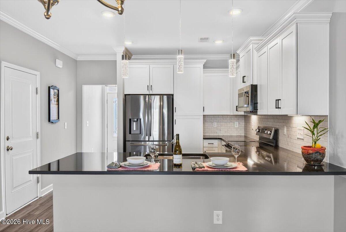 8840 Radcliff Drive Northwest Calabash, NC 28467 - Photo 15 of 54 Another kitchen angle highlighting the open flow and convenient layout.