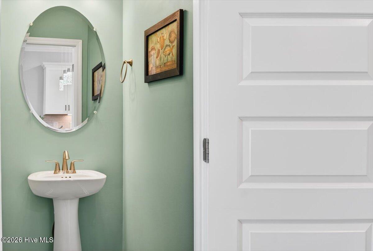 8840 Radcliff Drive Northwest Calabash, NC 28467 - Photo 30 of 54 First level half bathroom for added convenience.