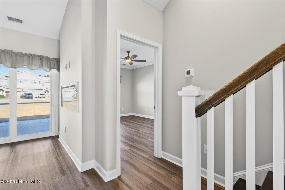 8840 Radcliff Drive Northwest Calabash, NC 28467 - Photo 31 of 54 View of the staircase that leads to the upper level living areas