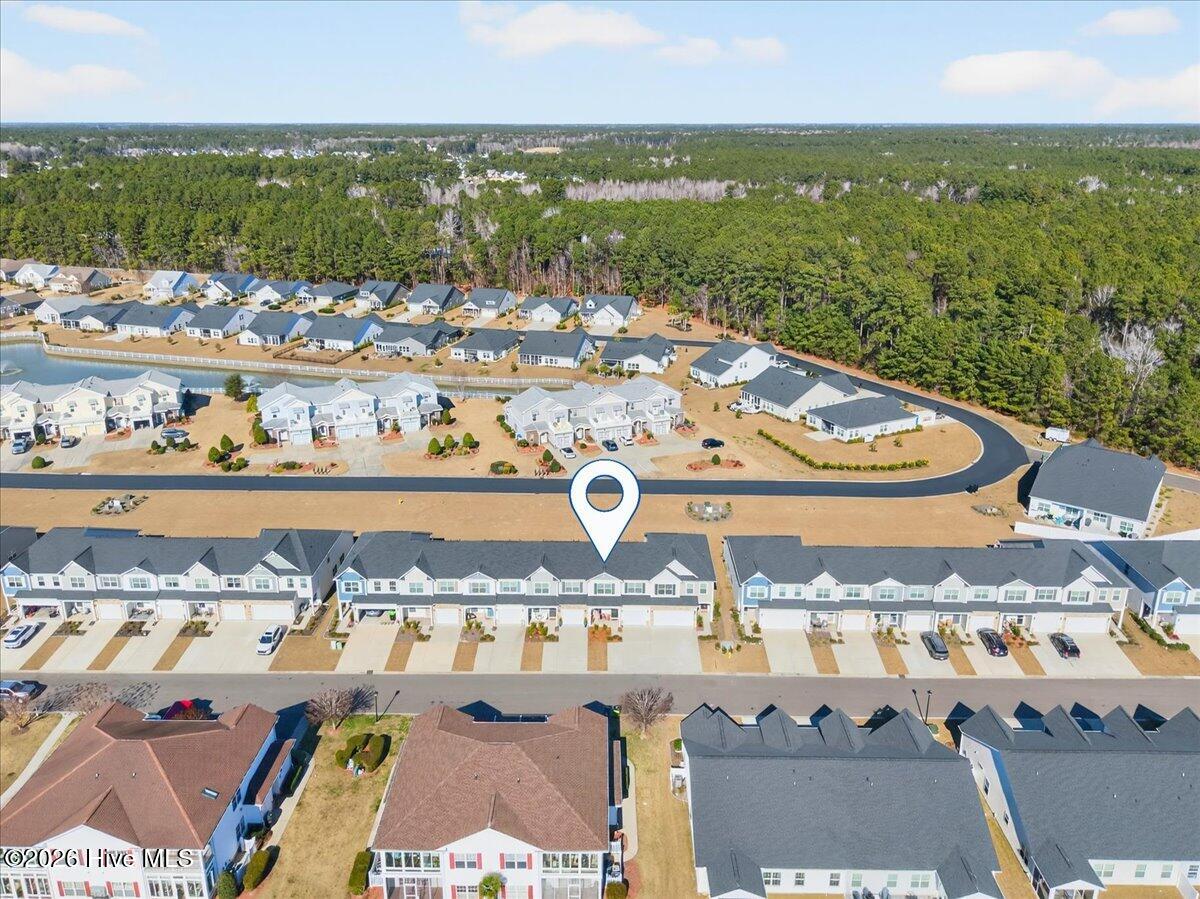 8840 Radcliff Drive Northwest Calabash, NC 28467 - Photo 48 of 54 Wide exterior aerial view featuring the home’s attractive façade and peaceful residential street.