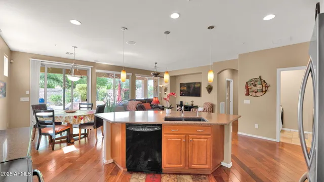 a view of a kitchen with dining room and wooden floor