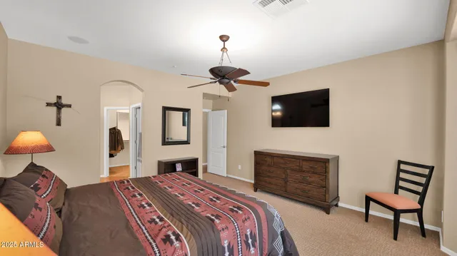 a bedroom with a bed and a television