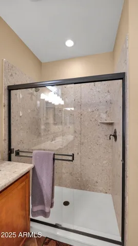 a bathroom with a glass shower door