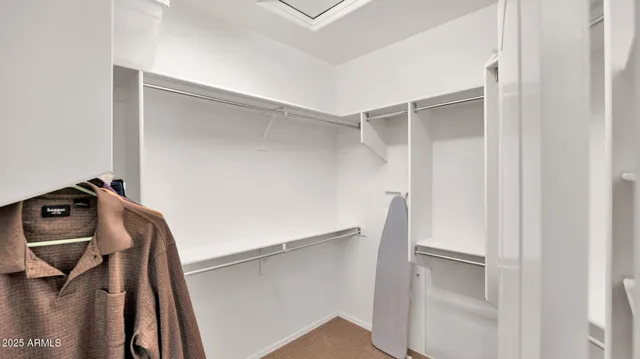 a view of walk in closet with empty racks