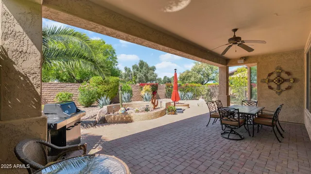 a living room with patio furniture and a floor to ceiling window