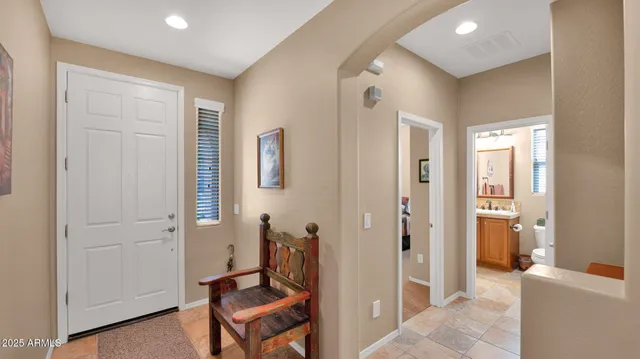 a view of a hallway with bathroom and a bathroom