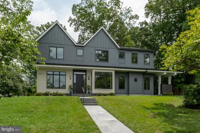 a front view of a house with a yard and garden