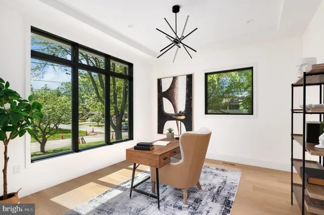 a dining room with furniture floor to ceiling windows and garden view