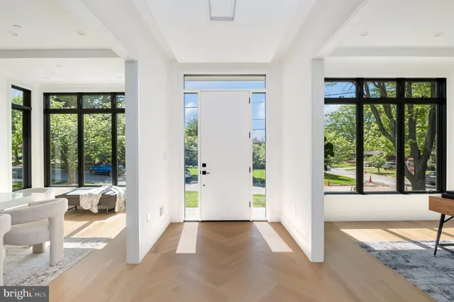 a view of an entryway with a floor to ceiling window and a living room