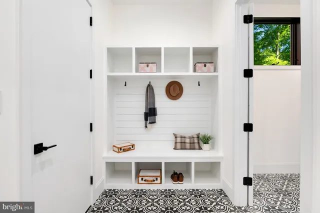 a bedroom with a large bed and windows