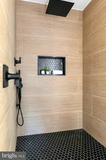 a bathroom with a tub sink and mirror