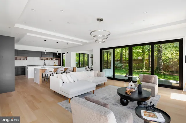 a living room with furniture and large windows