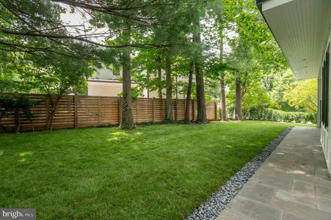 a view of a house with backyard and porch