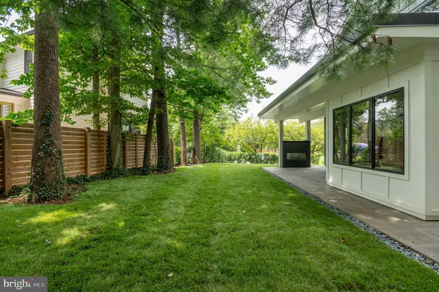 a front view of a house with a garden and garage