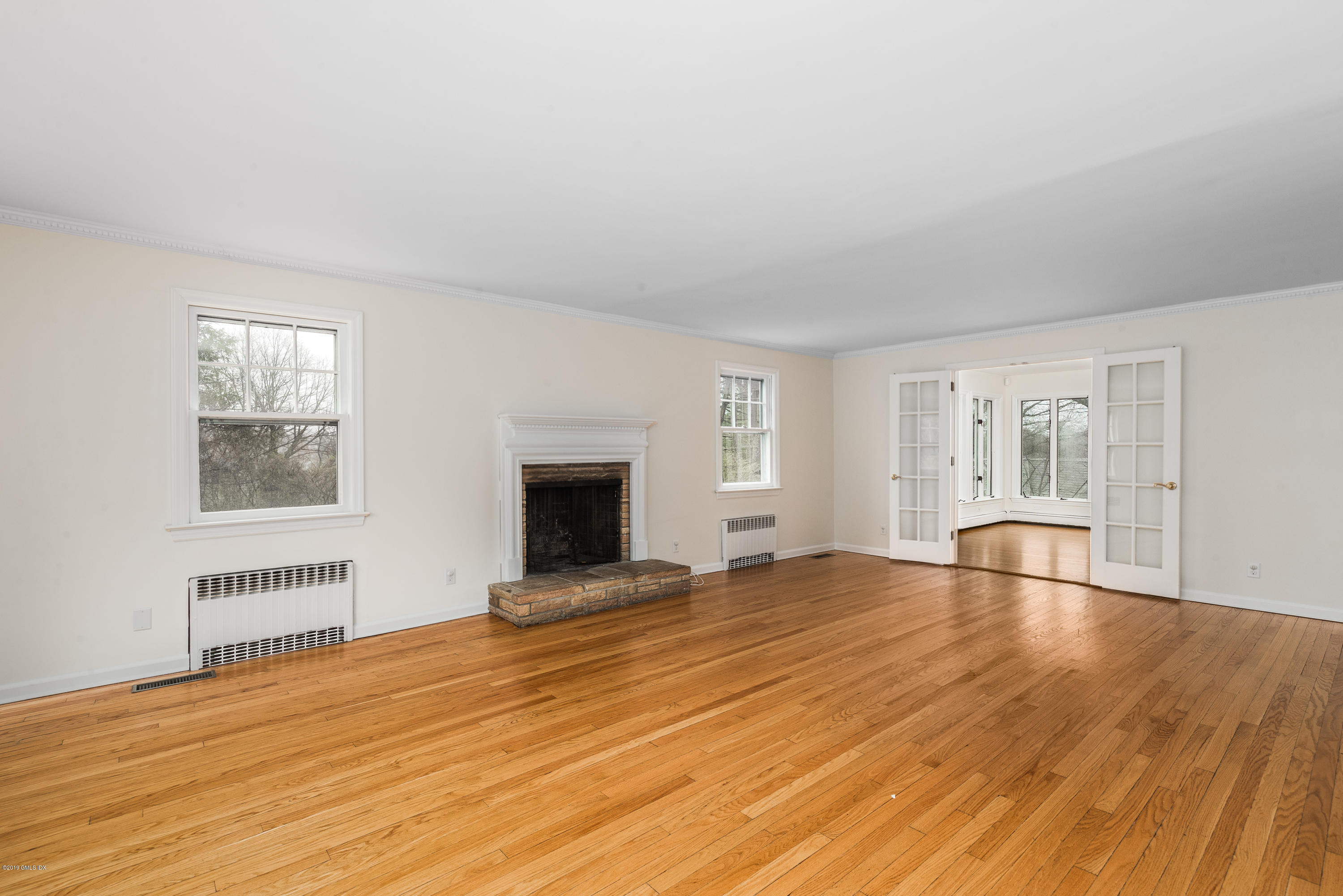 64 Wesskum Wood Road Riverside, CT 06878 - Photo 2 of 13 a view of empty room with wooden floor and fireplace