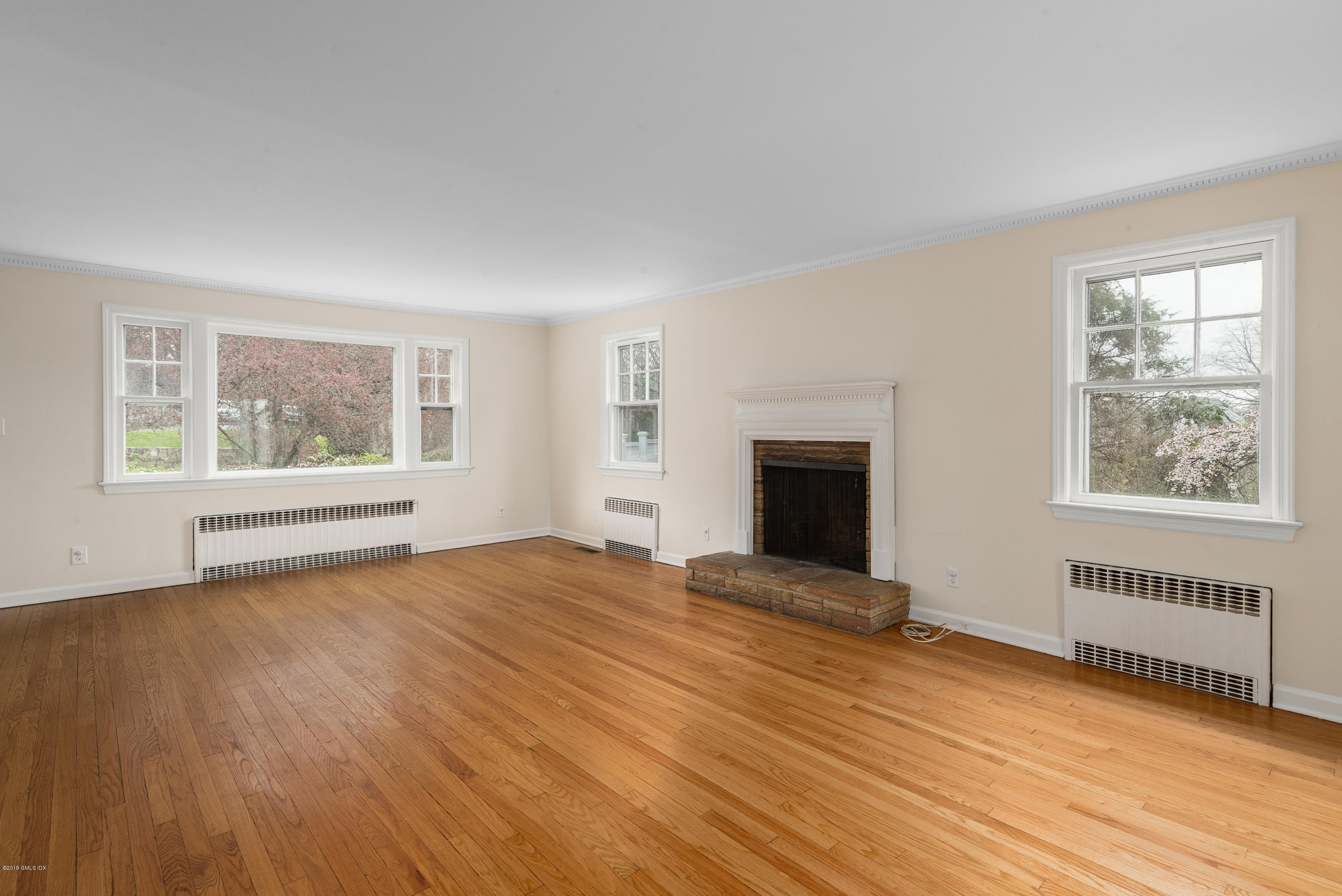64 Wesskum Wood Road Riverside, CT 06878 - Photo 3 of 13 a view of an empty room with wooden floor and a window