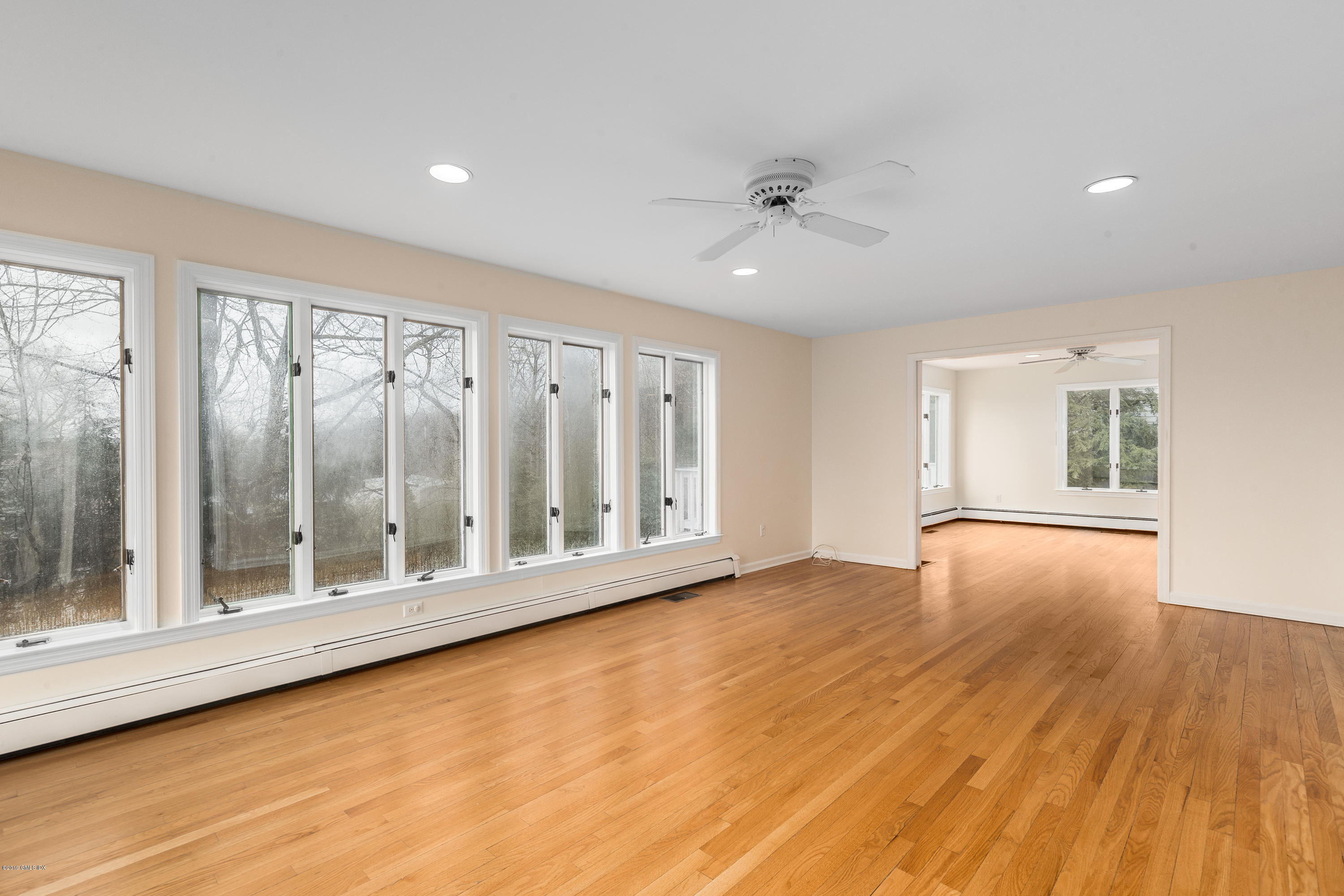 64 Wesskum Wood Road Riverside, CT 06878 - Photo 4 of 13 a view of an empty room with wooden floor and a window