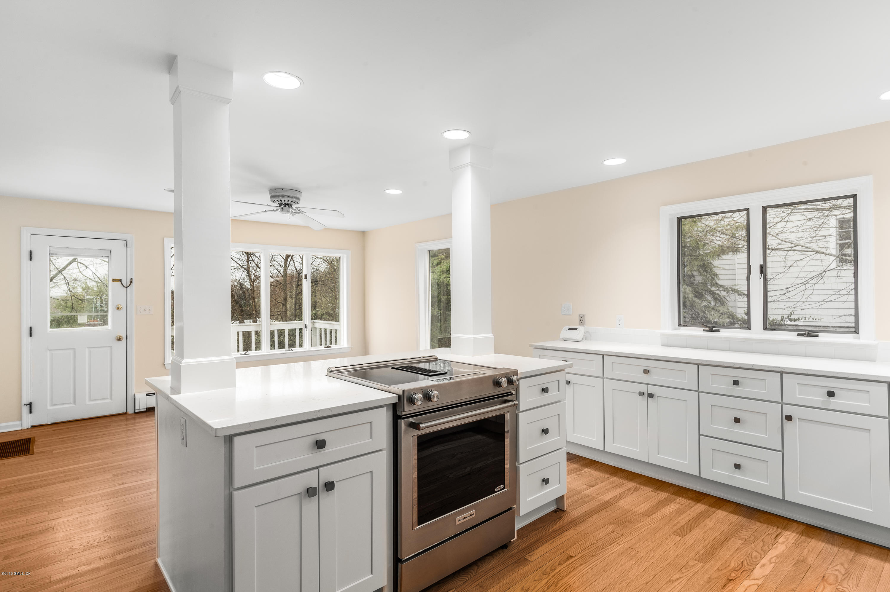 64 Wesskum Wood Road Riverside, CT 06878 - Photo 5 of 13 a kitchen with granite countertop white cabinets and wooden floor