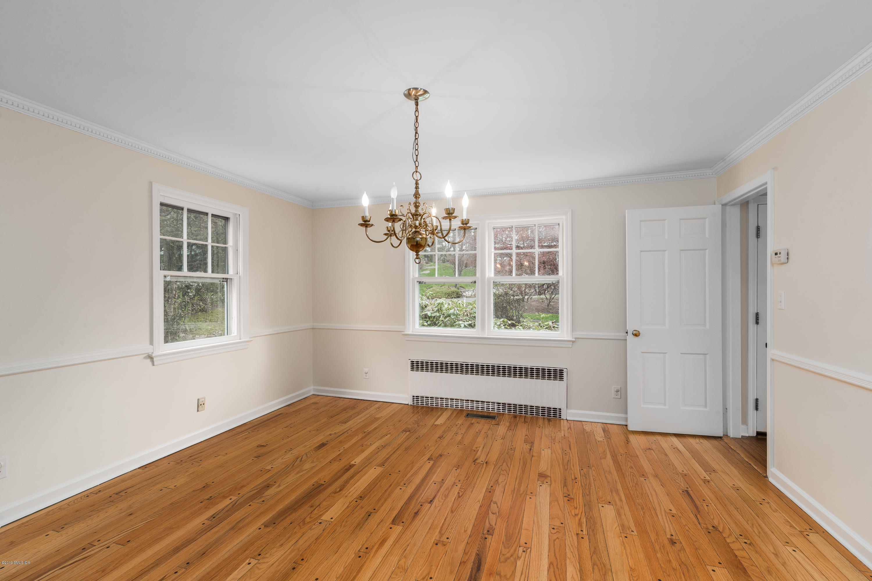 64 Wesskum Wood Road Riverside, CT 06878 - Photo 6 of 13 a view of an empty room with wooden floor and a window