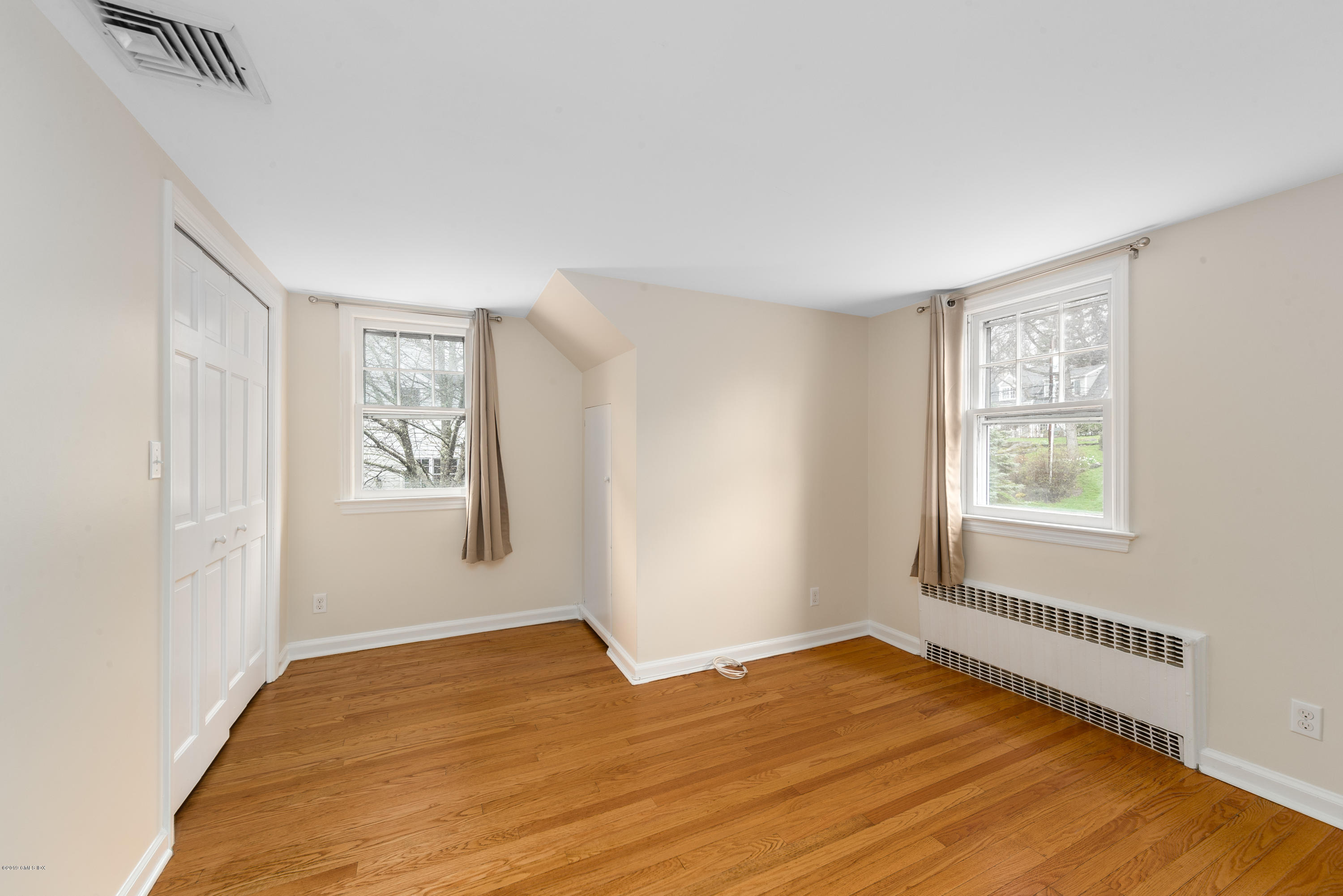 64 Wesskum Wood Road Riverside, CT 06878 - Photo 7 of 13 a view of an empty room with wooden floor and a window