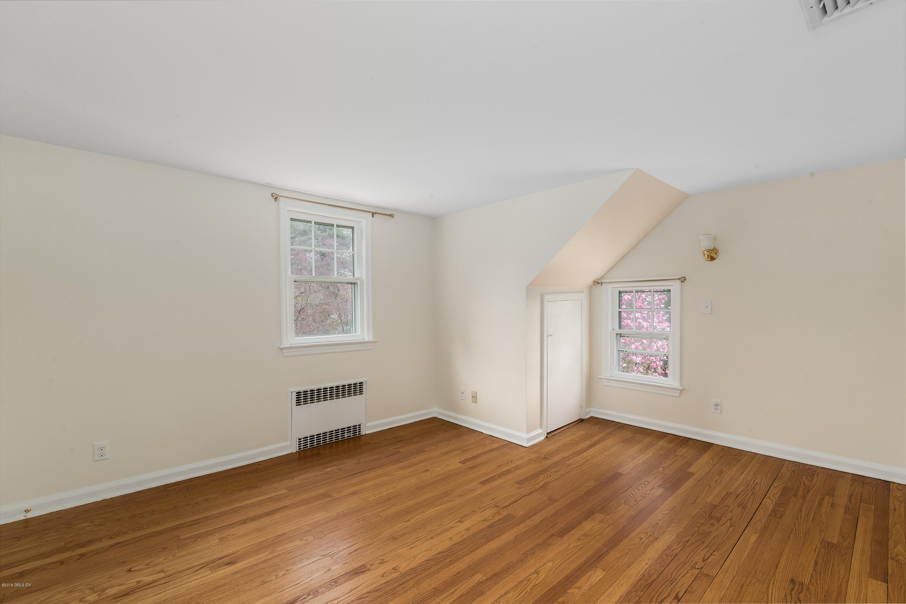 64 Wesskum Wood Road Riverside, CT 06878 - Photo 8 of 13 an empty room with wooden floor and windows