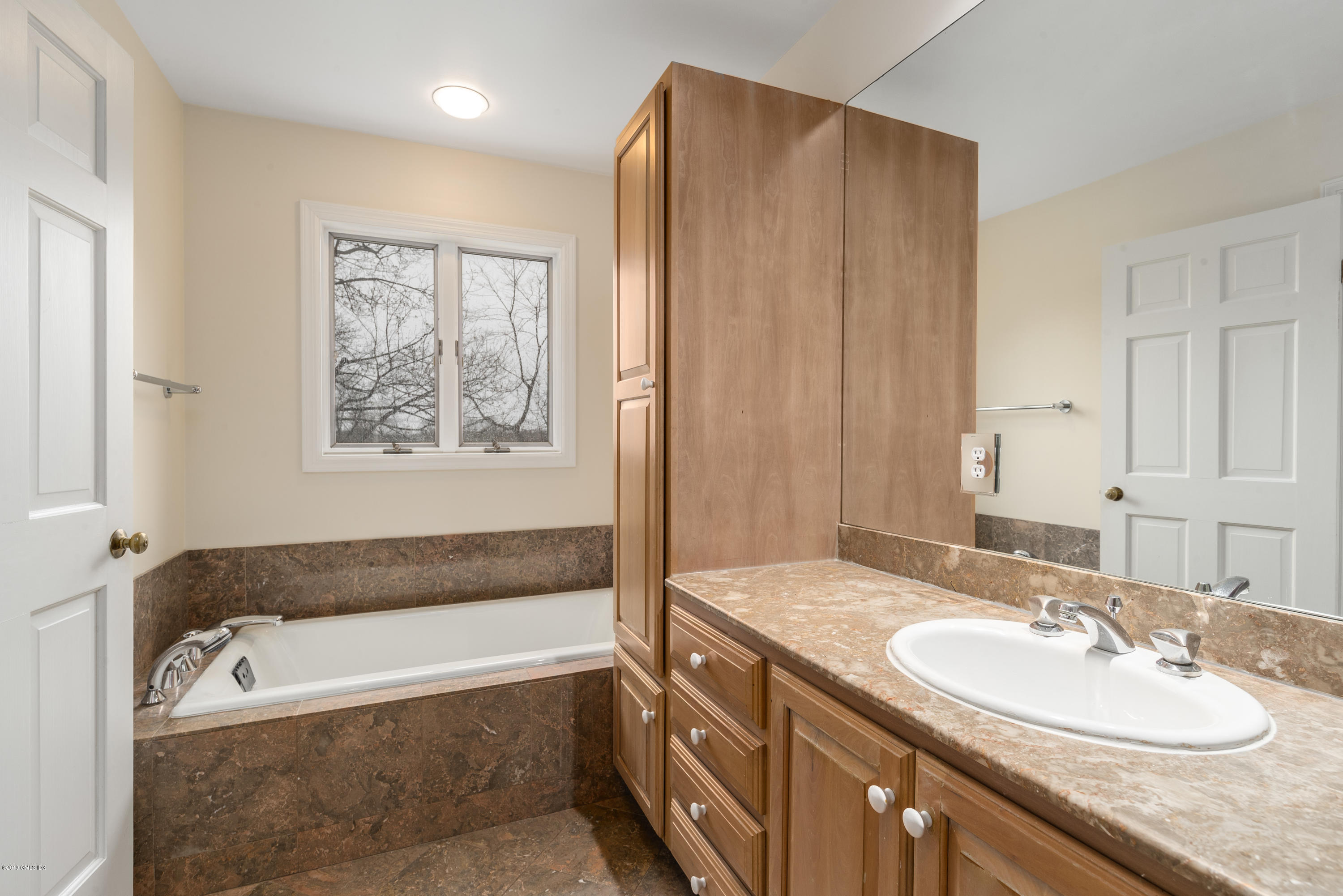 64 Wesskum Wood Road Riverside, CT 06878 - Photo 10 of 13 a bathroom with a granite countertop tub sink and mirror