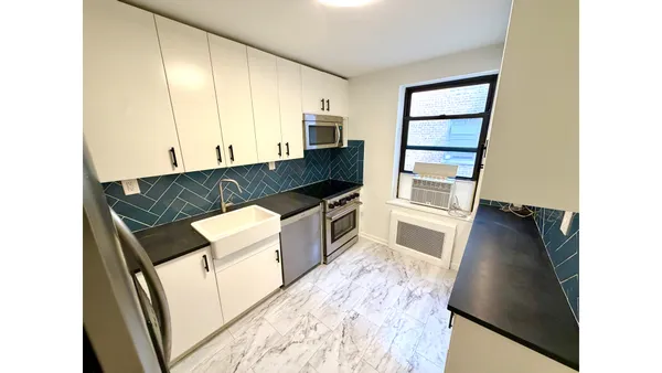 a kitchen with granite countertop a stove and a refrigerator