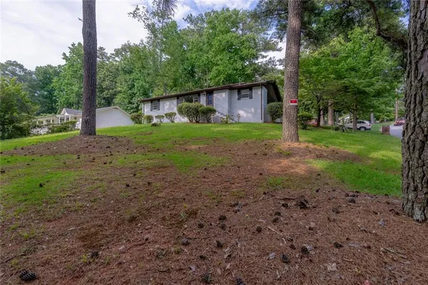a view of a house with yard and tree s