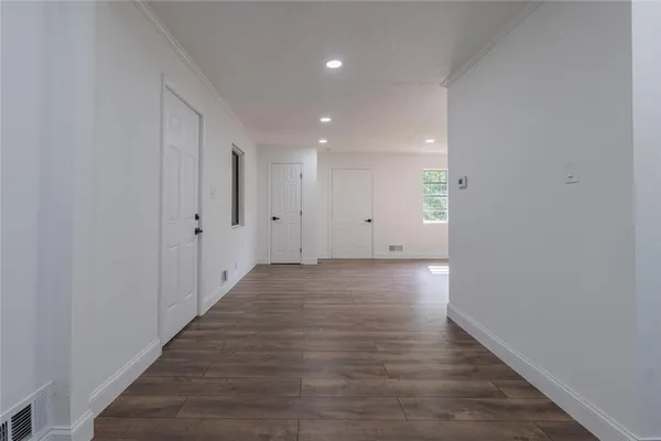 a view of hallway with wooden floor