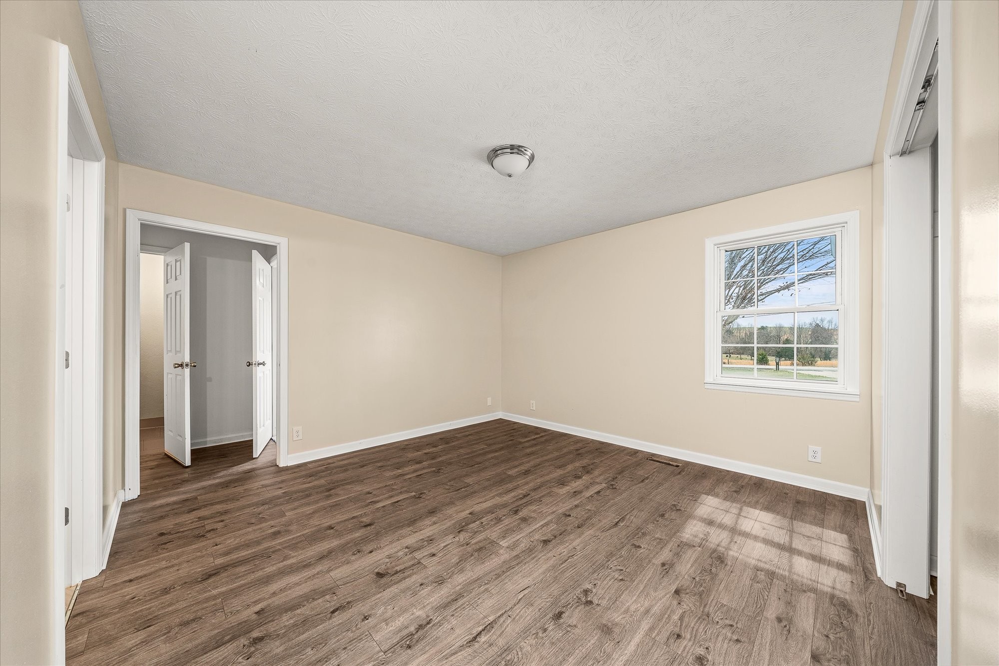 11216 Clay County Highway Moss, TN 38575 - Photo 12 of 40 a view of an empty room with wooden floor and a window