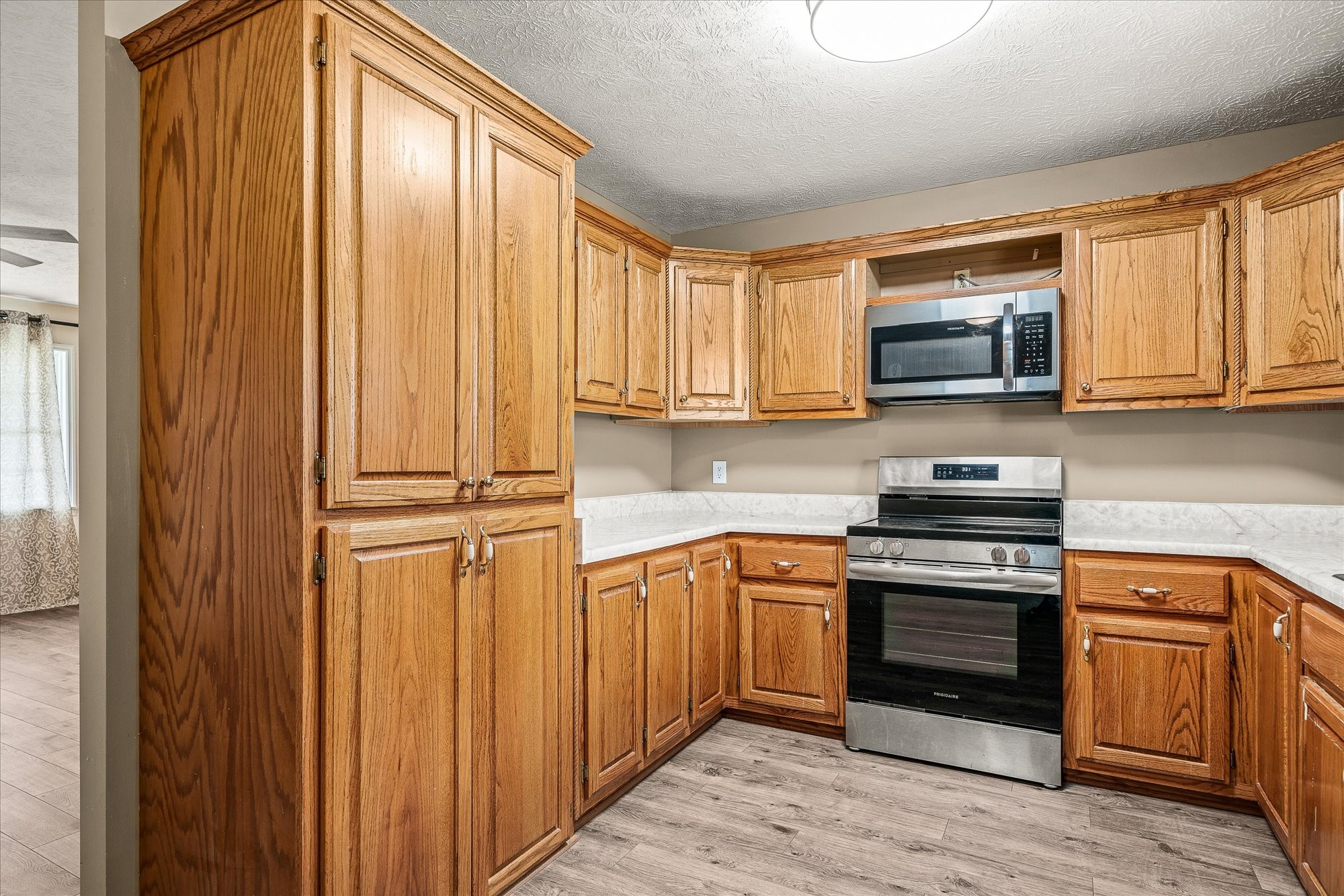 11216 Clay County Highway Moss, TN 38575 - Photo 3 of 40 a kitchen with stainless steel appliances granite countertop a stove top oven a sink and dishwasher with wooden cabinets