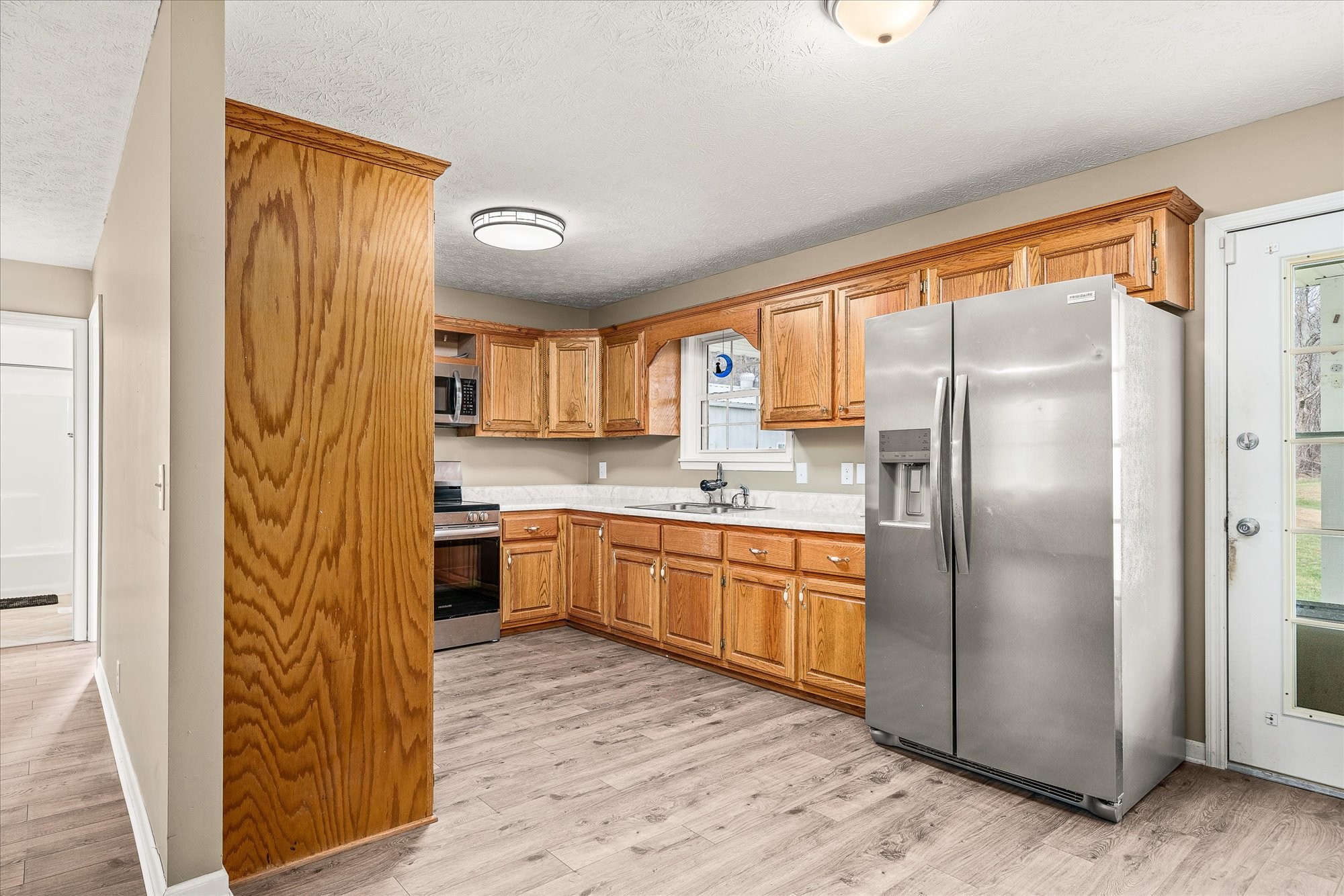 11216 Clay County Highway Moss, TN 38575 - Photo 4 of 40 a kitchen with stainless steel appliances granite countertop a refrigerator and a stove top oven