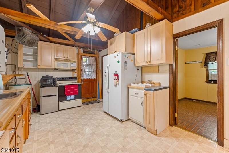 308 Lakeside Avenue Hopatcong, NJ 07821 - Photo 5 of 13 a kitchen with stainless steel appliances kitchen island granite countertop a refrigerator a stove and a sink with granite countertops