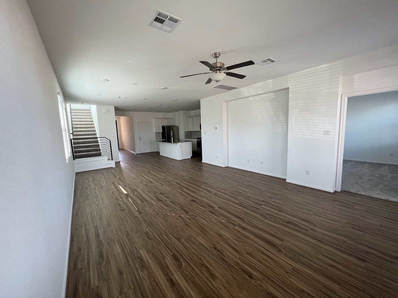 313 Montauk Loop Georgetown, TX 78628 - Photo 12 of 25 a view of a room with wooden floor and ceiling fan