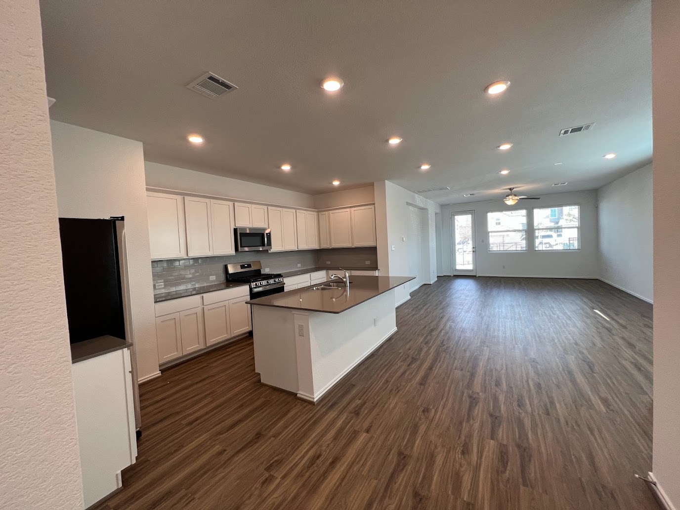 313 Montauk Loop Georgetown, TX 78628 - Photo 24 of 25 a large white kitchen with lots of counter space a sink dishwasher and a refrigerator