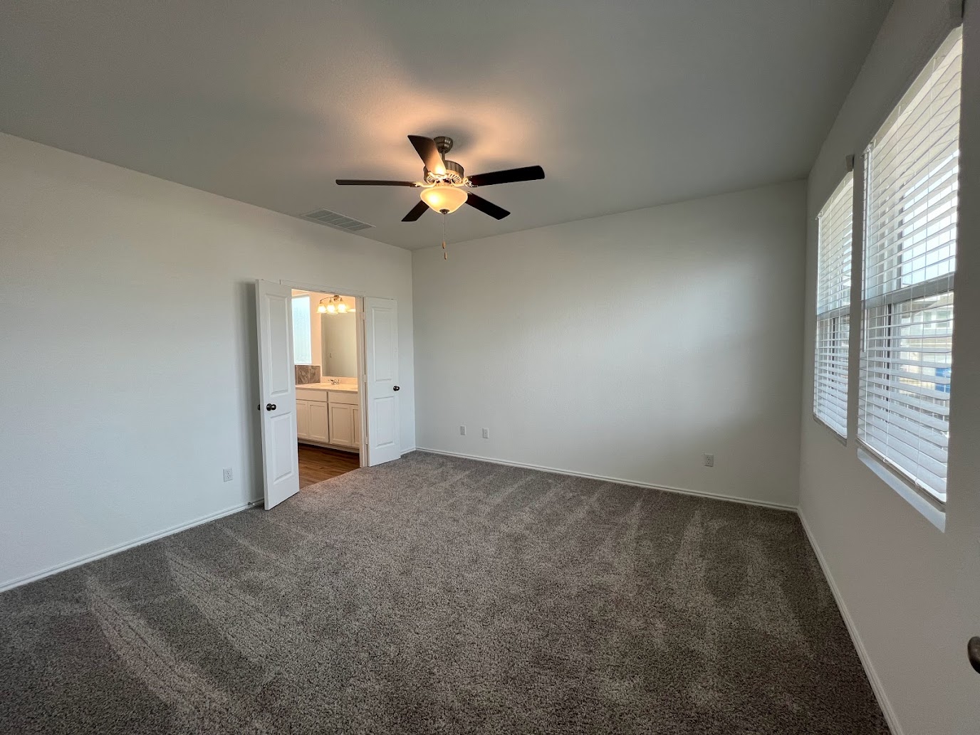 313 Montauk Loop Georgetown, TX 78628 - Photo 5 of 25 an empty room with a window and a fan