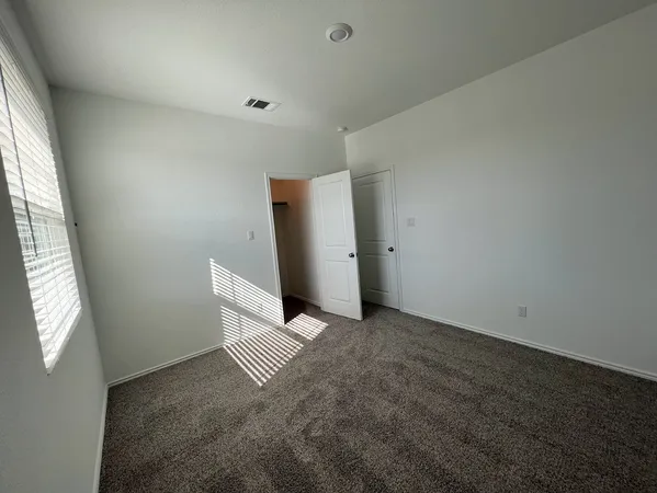 a view of a big room with closet and wooden floor