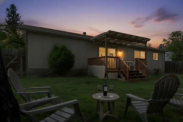 a backyard of a house with seating space and furniture