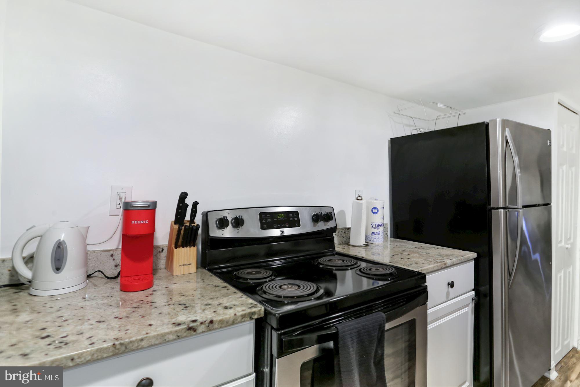 952 Shepherd Street Northwest Washington, DC 20011 - Photo 10 of 16 a kitchen with stainless steel appliances granite countertop a sink stove and refrigerator