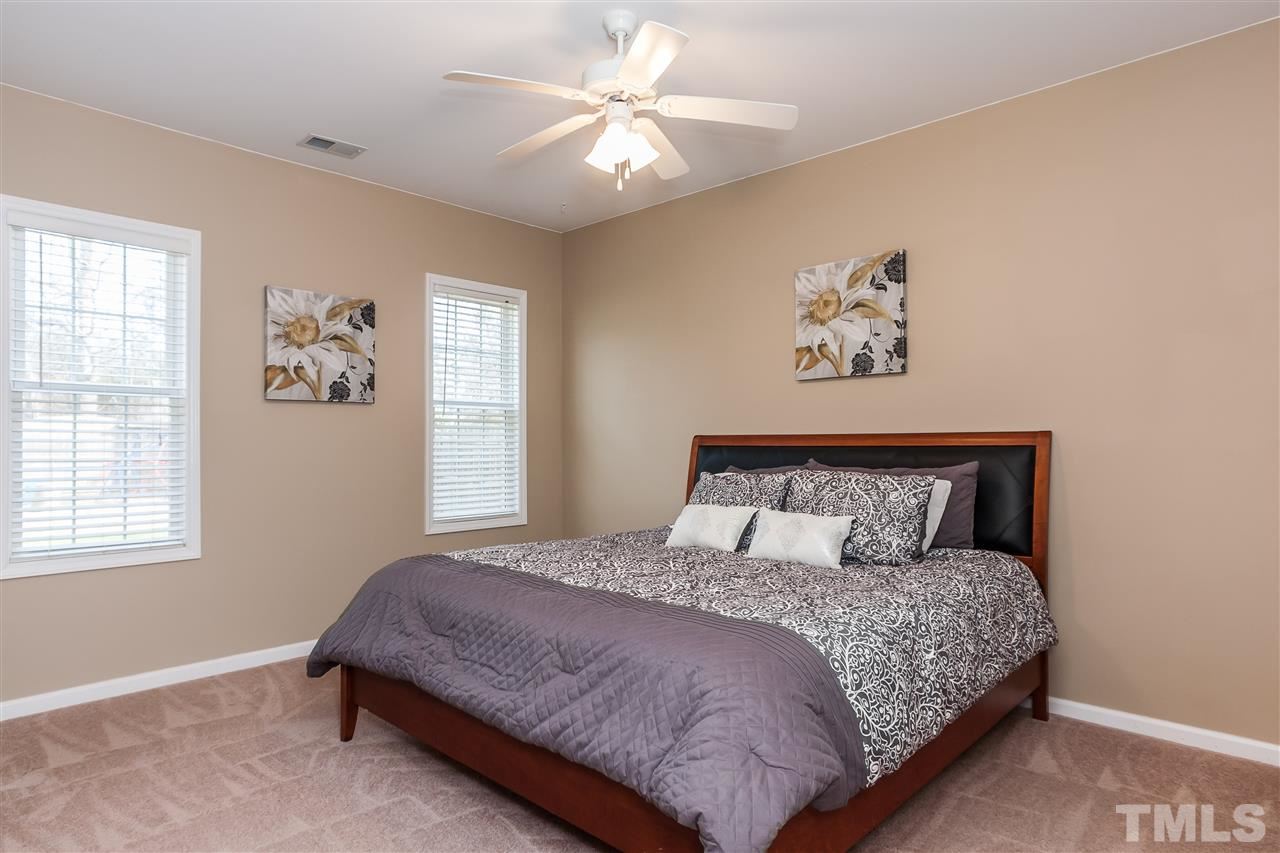 5421 Neuse Forest Road Raleigh, NC 27616 - Photo 12 of 21 a bedroom with a large bed and a window