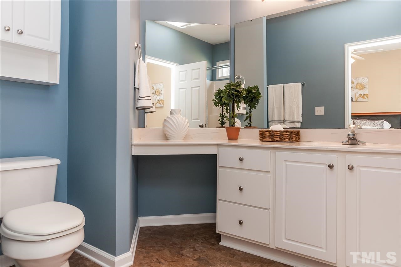 5421 Neuse Forest Road Raleigh, NC 27616 - Photo 13 of 21 a bathroom with a toilet sink and mirror