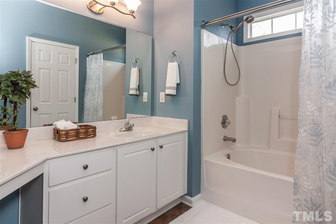 5421 Neuse Forest Road Raleigh, NC 27616 - Photo 14 of 21 a bathroom with a granite countertop sink mirror and a bathtub