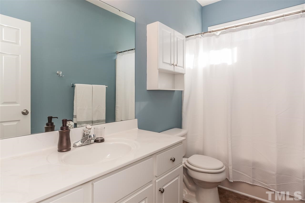 5421 Neuse Forest Road Raleigh, NC 27616 - Photo 16 of 21 a bathroom with a sink and a mirror