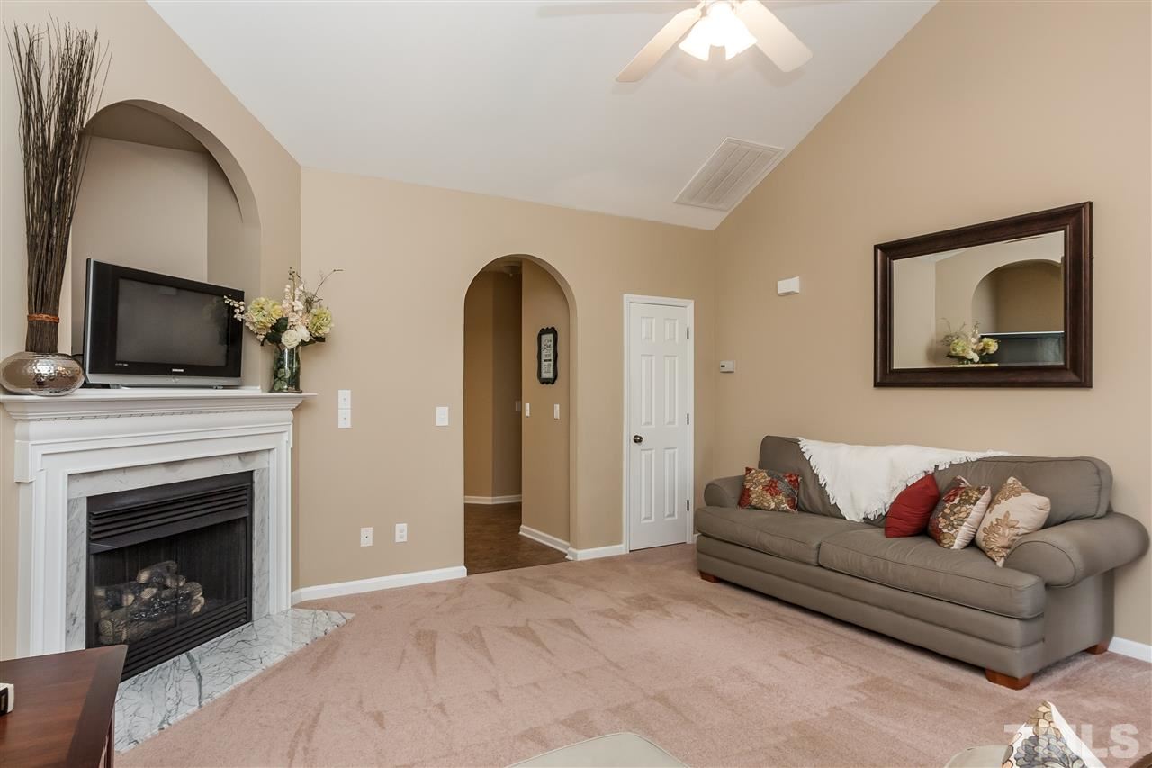 5421 Neuse Forest Road Raleigh, NC 27616 - Photo 5 of 21 a living room with furniture and a fireplace