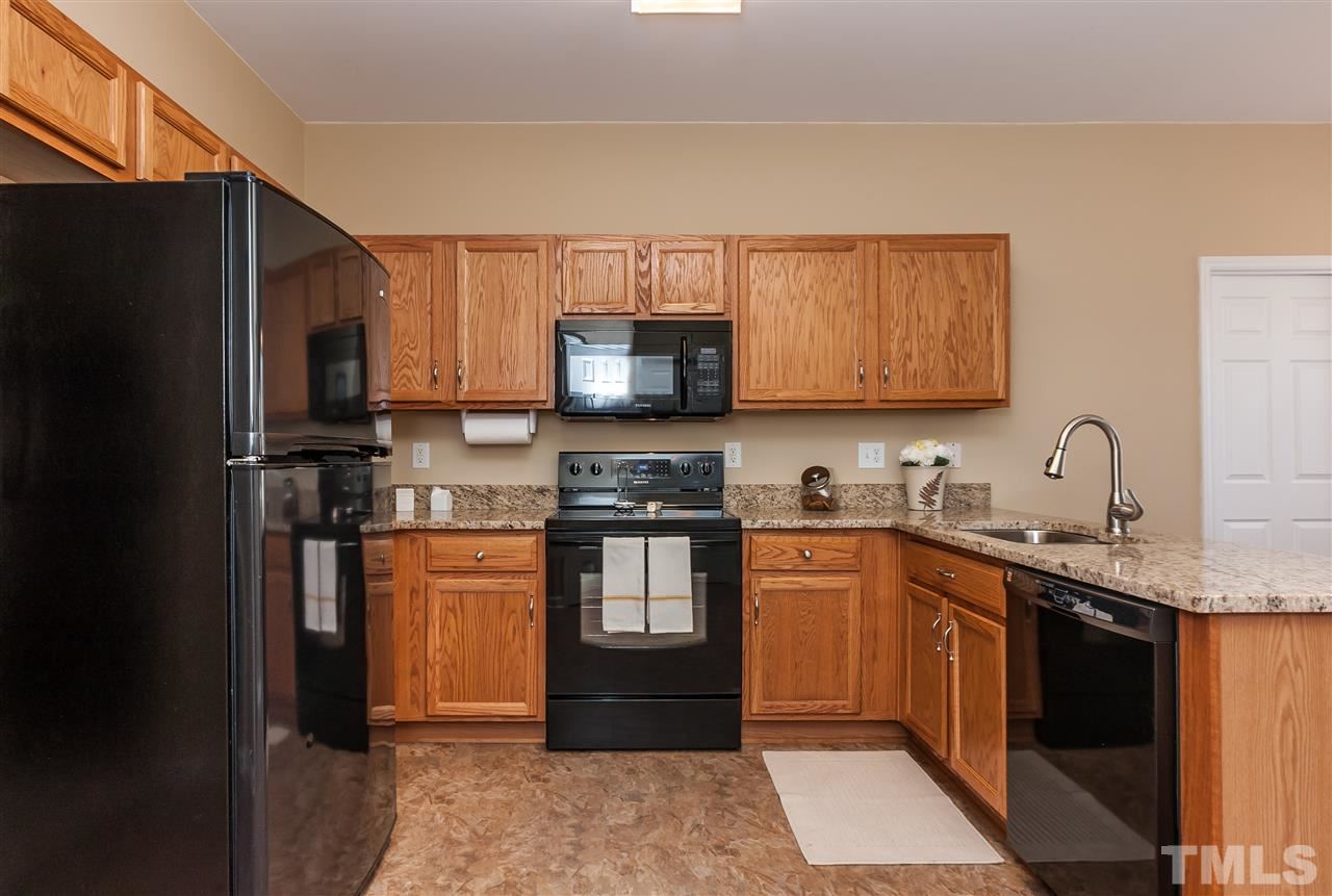 5421 Neuse Forest Road Raleigh, NC 27616 - Photo 8 of 21 a kitchen with stainless steel appliances granite countertop a refrigerator stove and sink