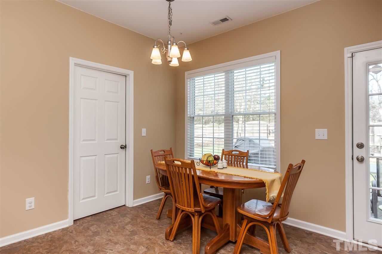 5421 Neuse Forest Road Raleigh, NC 27616 - Photo 10 of 21 a dining room with furniture a chandelier and window