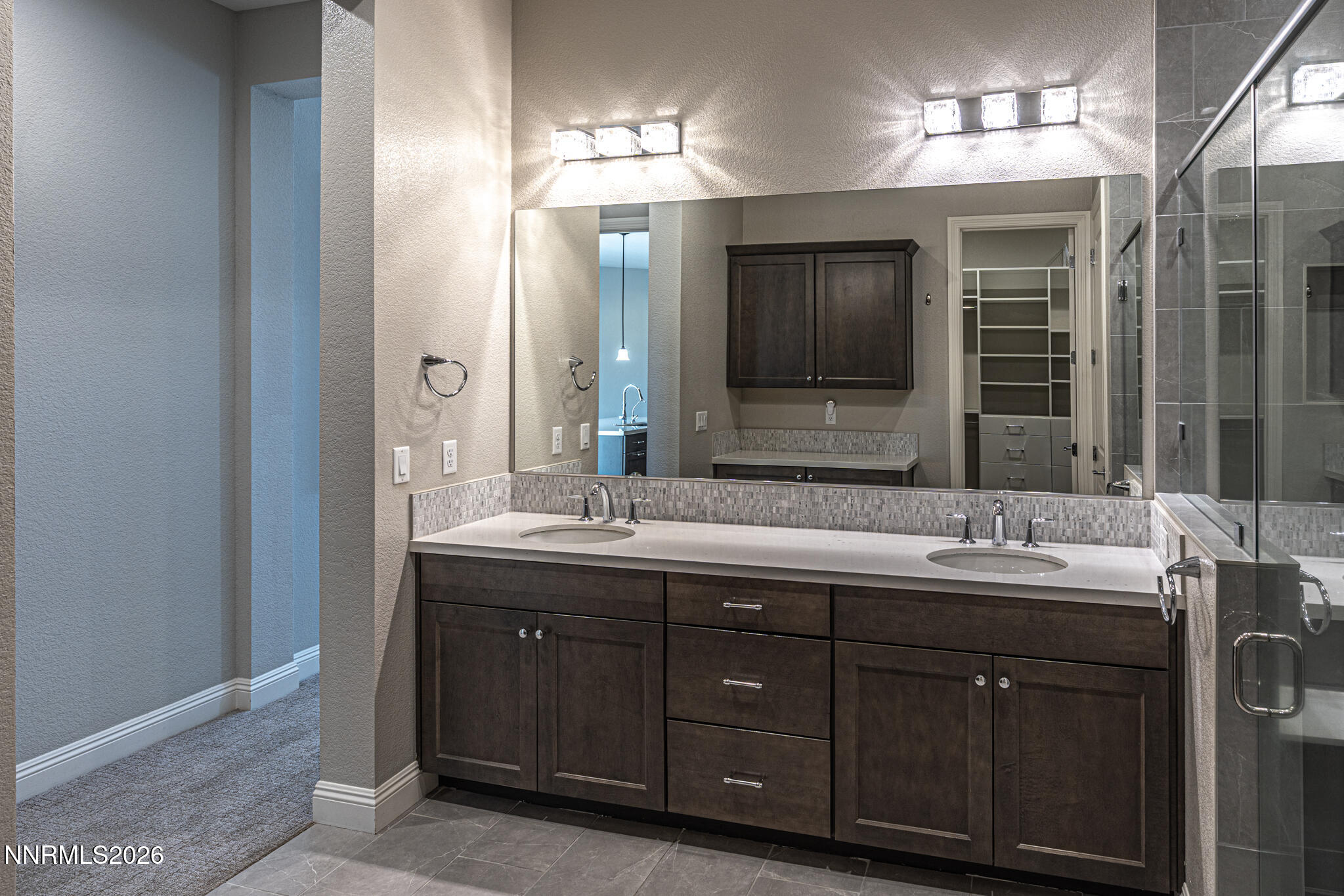 2109 Cast Iron Drive Reno, NV 89521 - Photo 17 of 35 a bathroom with a double vanity sink and a mirror