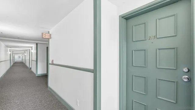 a view of a hallway with closet and front door